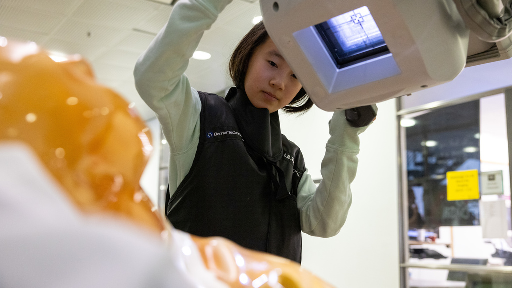 A young girl uses a simulation x-ray machine